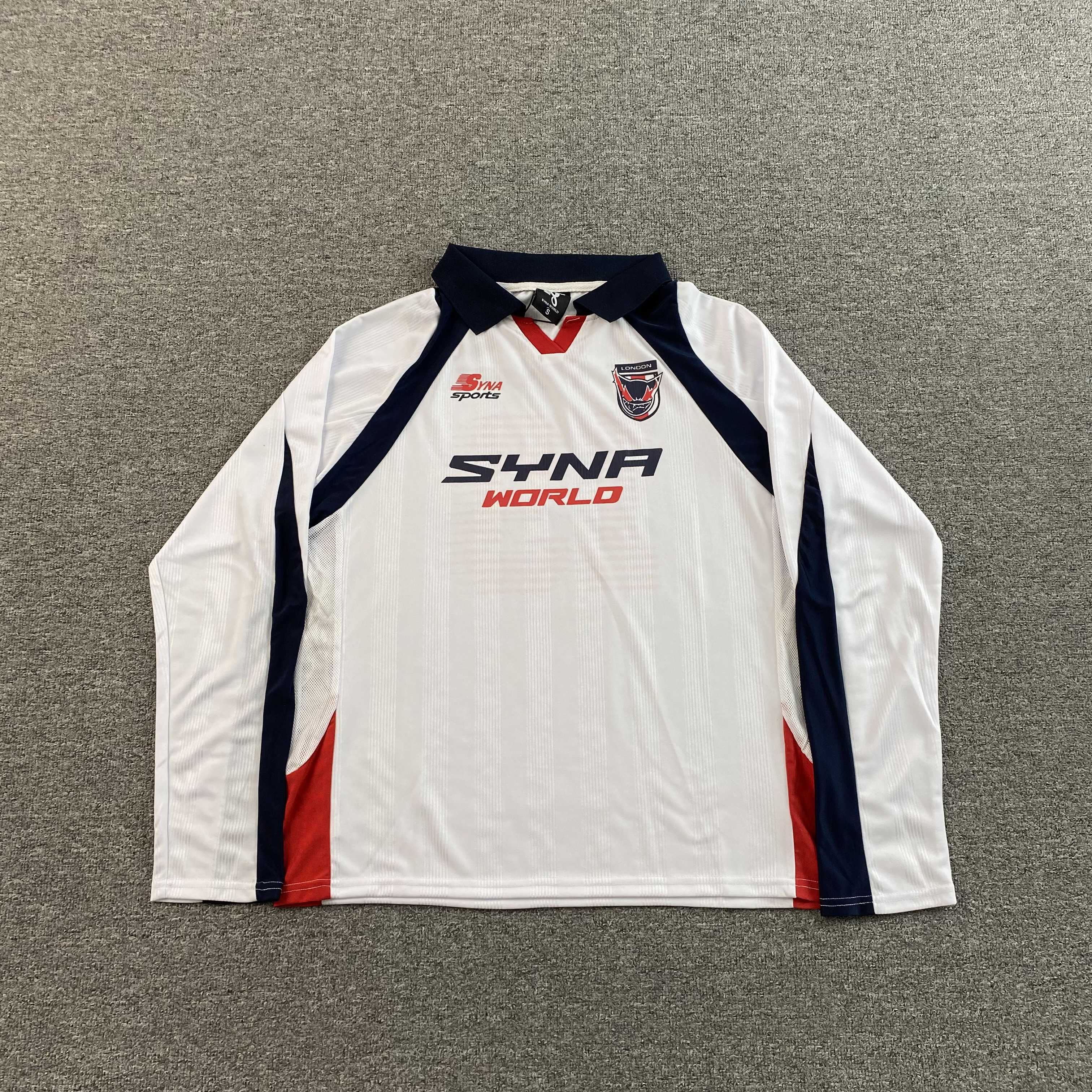 SYNA WORLD DVL FOOTY V2 T SHIRT